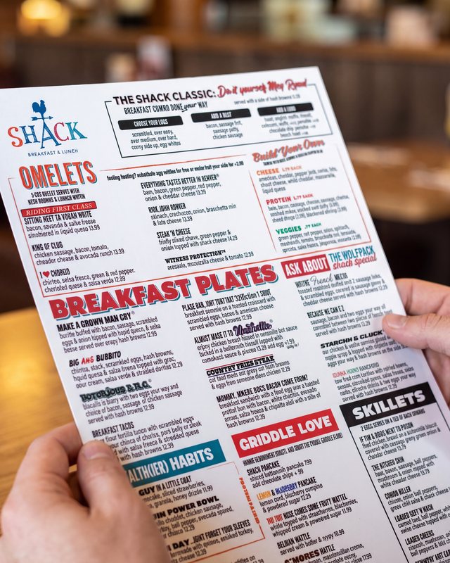 Shack Breakfast & Lunch printed menu held in hand